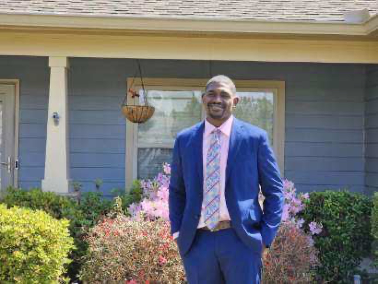 Cartez wearing a suit outdoors