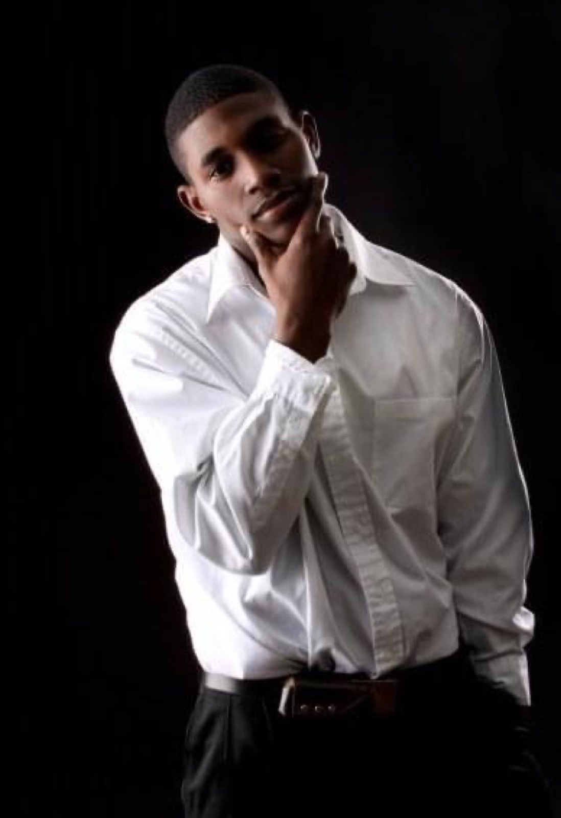 A studio portrait of Cartez in a white shirt